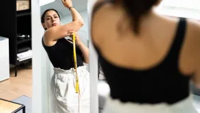 Woman Checking Herself In Front Of A Mirror