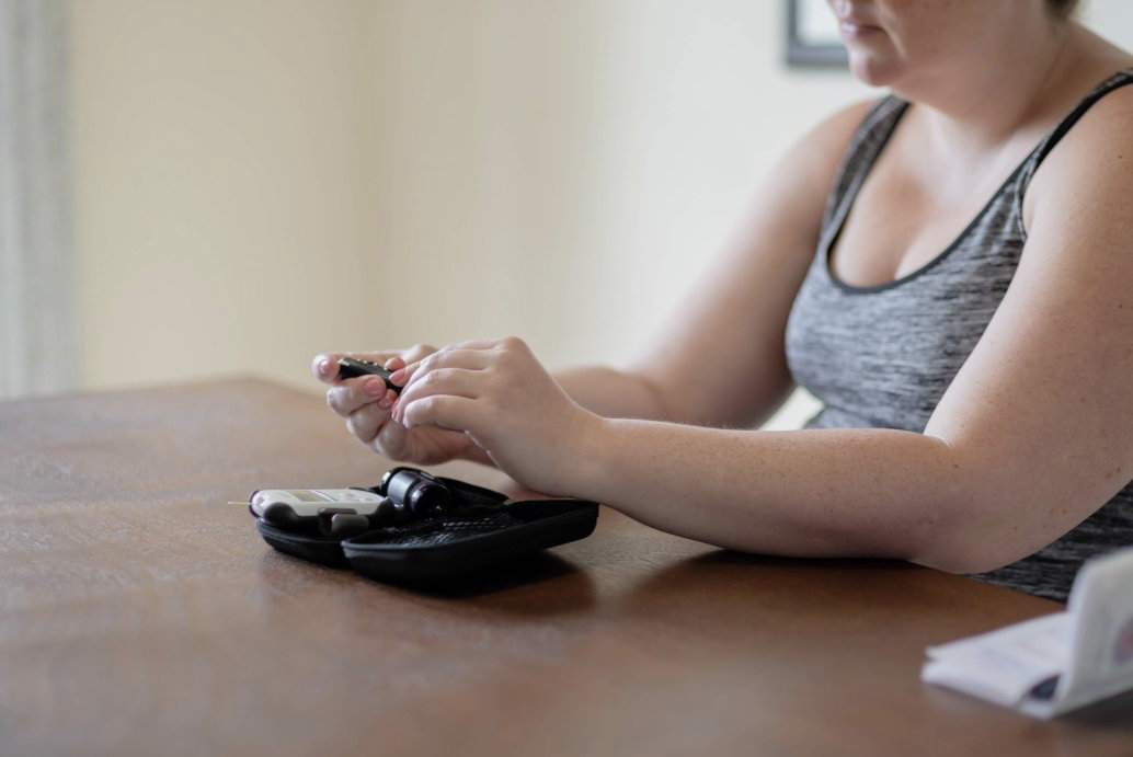 Young woman with diabetes testing blood glucose levels.