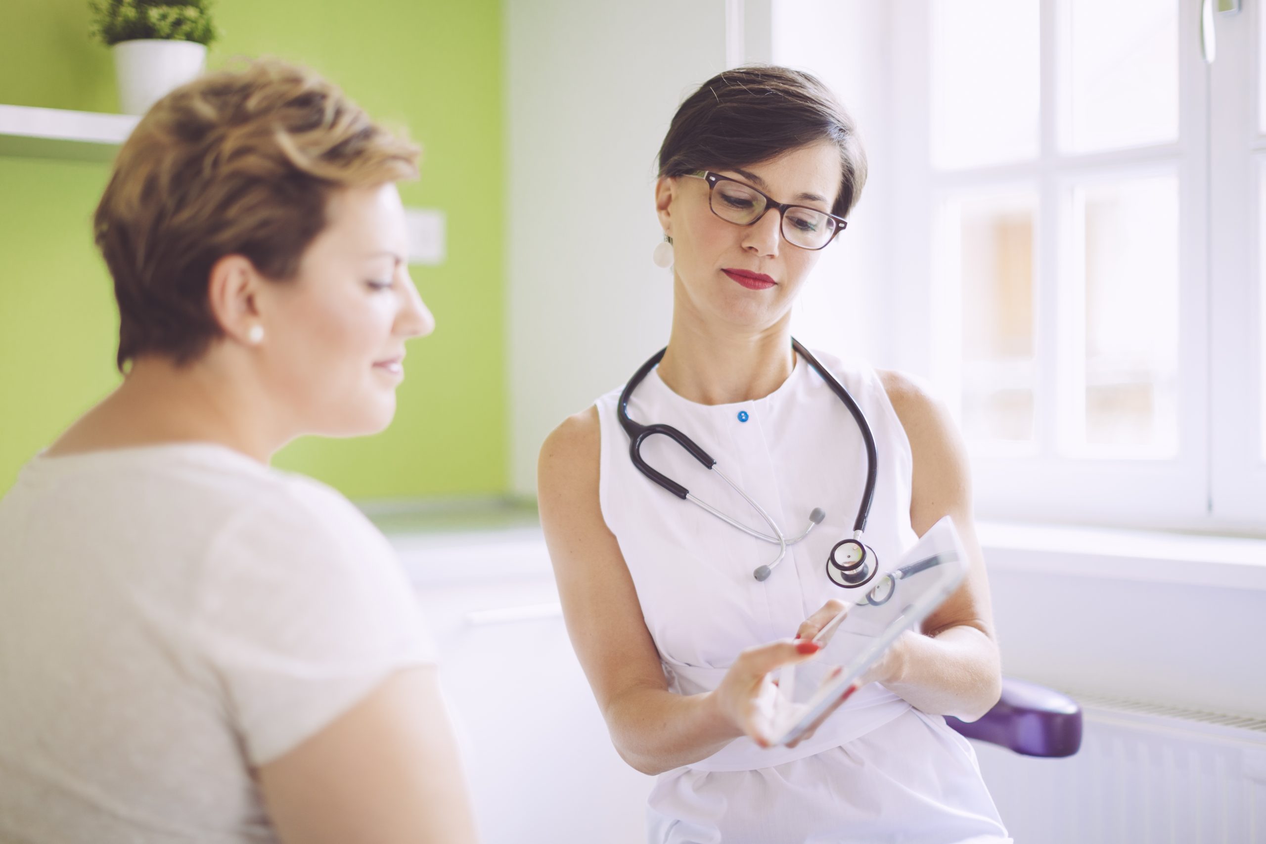 Digital Tablet Being Viewed By Patient And Doctor