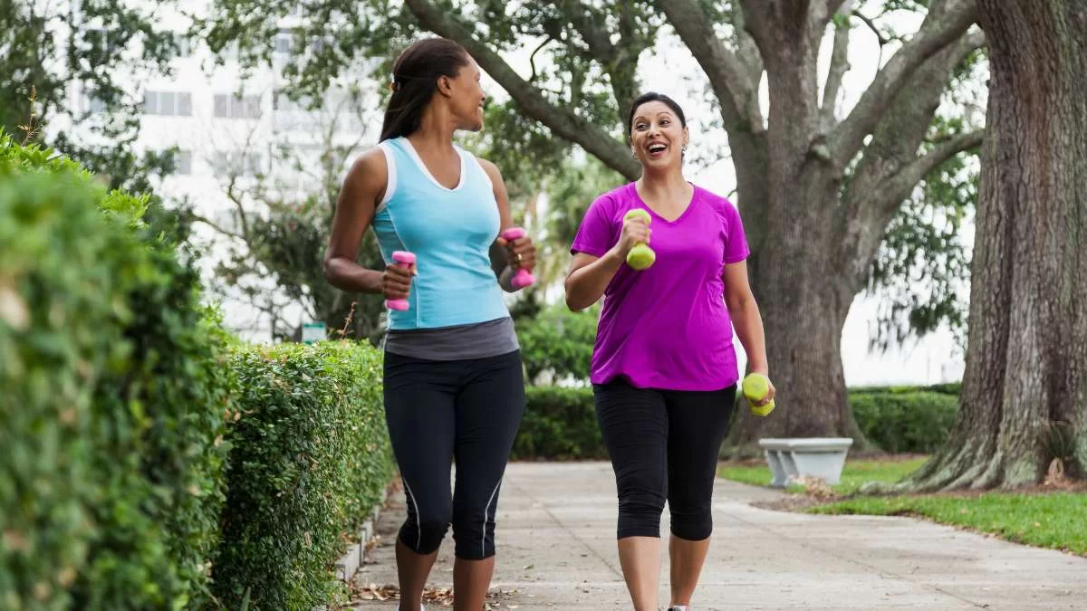 Women Holding Weights On A Sidewalk