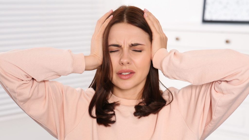 Woman Holding Her Head in Pain