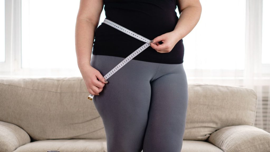 Woman Measuring Hips With Measure Tape